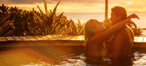 Couple enjoying a 3-day Rwanda honeymoon safari with gorilla trekking and golden monkey tracking in lush forest.